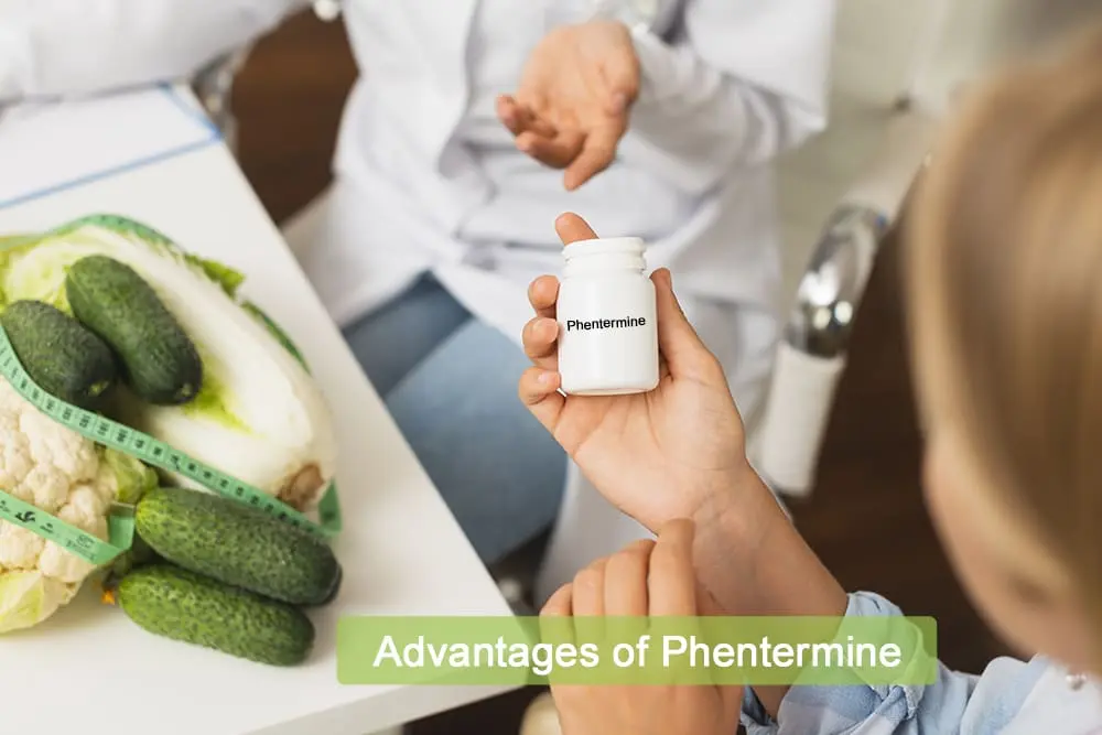 Person holding a bottle labeled Phentermine with vegetables and a measuring tape on the table